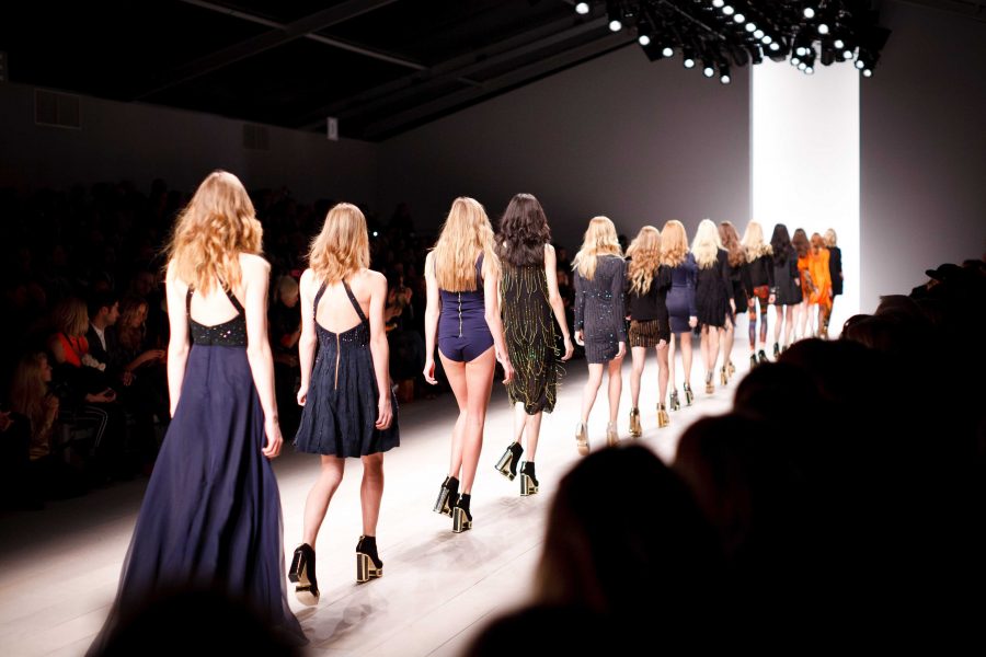 Female models on the runway at a fashion show.