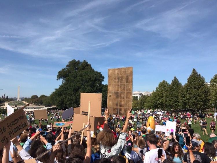 Crowds of student protestors march with posters demanding action during the 2019 D.C. climate change rally.