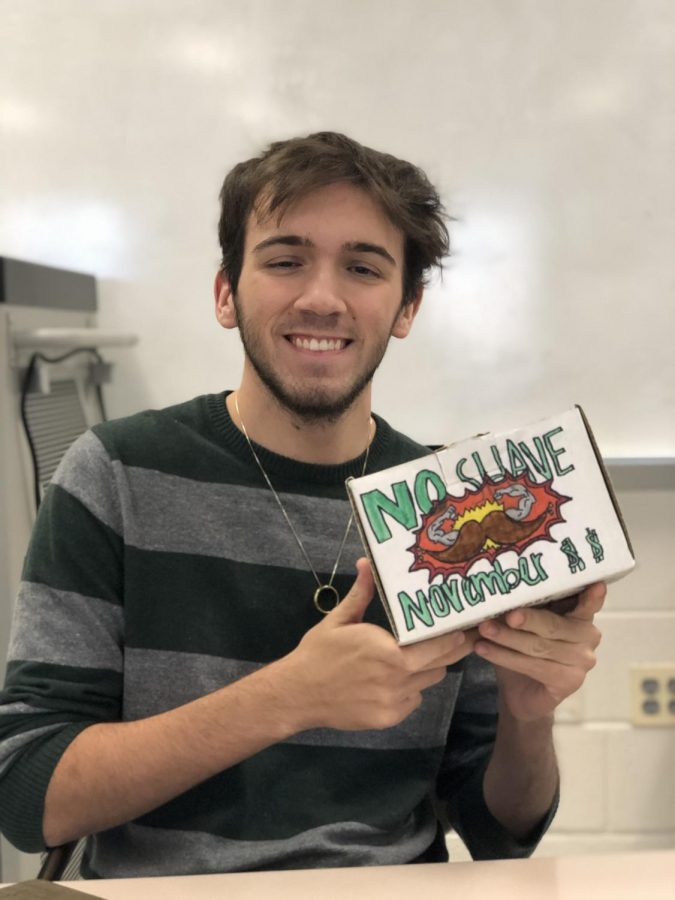 Senior Kevin Hrozencik displays his  decorated donation box.