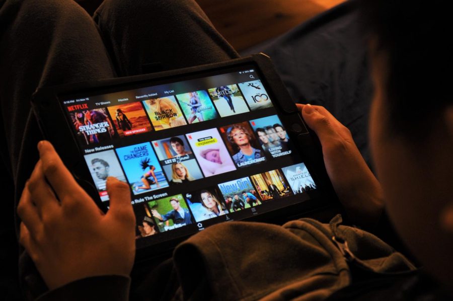 A student scrolls through movies offered on the Netflix streaming service.