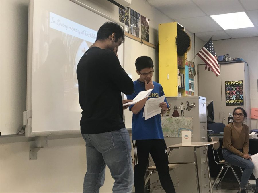 Seniors Leshan Viswanath and Isaac Lim perform part of a skit for their groups presentation on The Adventures of Huckleberry Finn in the IB English Literature 2 class.