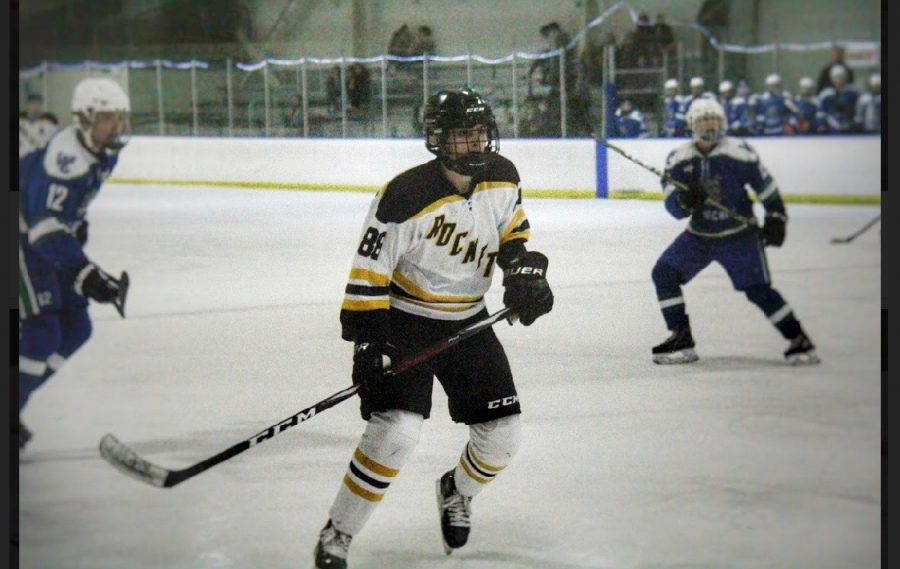 Senior Justin Culp-Gonzalez observes the puck as he skates down the ice. 