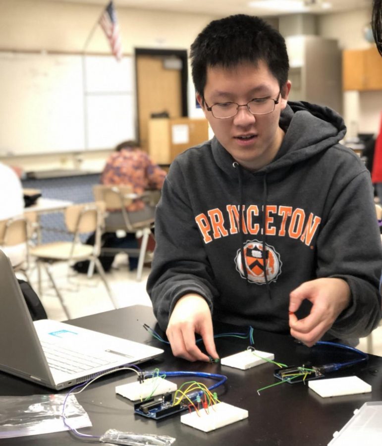 Senior Eric Yi builds a temperature sensing device for the Maryland regional Science Olympiad competition. 
