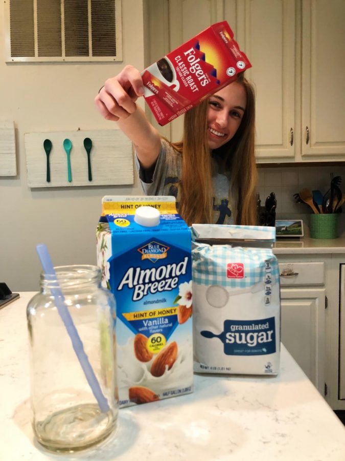 Brooke Hilliard posing with all the ingredients for a perfect cup of whipped coffee