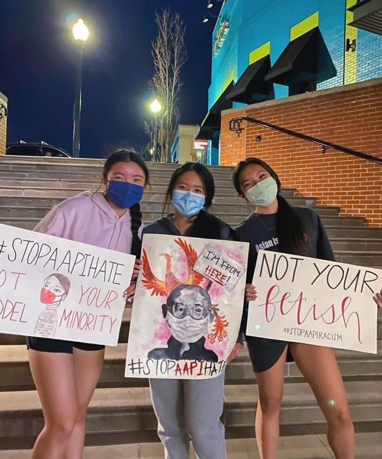 Eileen Chen, Jessie Chen, and Kaia Lee-Espiritu, who are leaders of RMs Asian American Club, hold posters at the Stop AAPI Hate March and Vigil in Silver Spring on March 26.