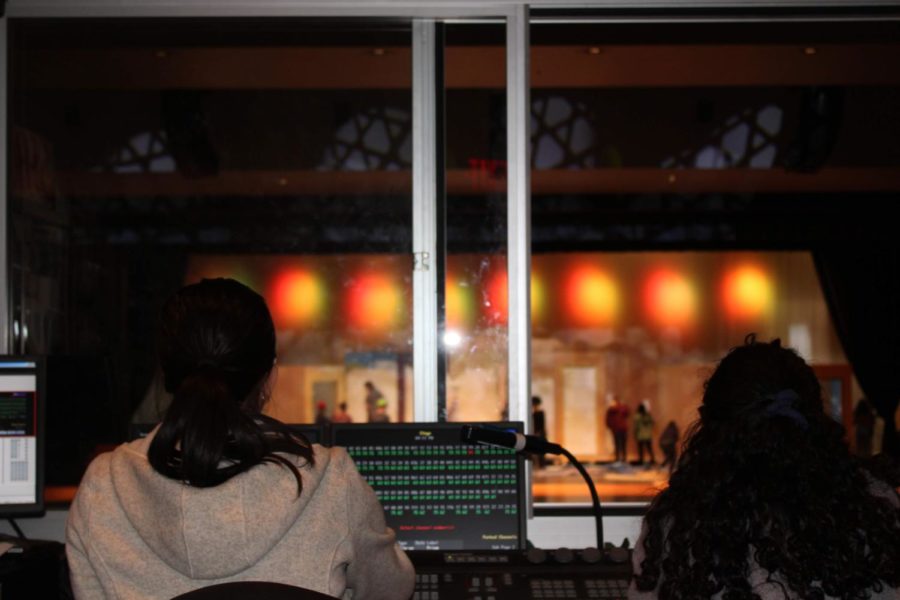Black Maskers crew members working in the sound and lighting booth. Photo by Ella Koenig 