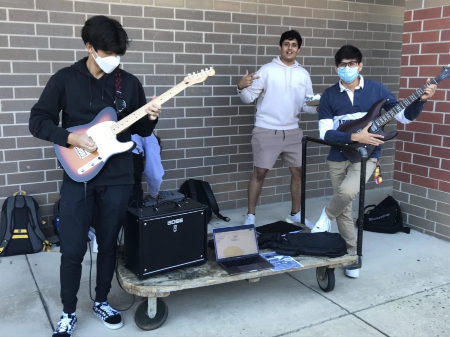 With his guitar out and ready, senior Patrick Kim attempts to recruit students to join the RM Rock & Metal Club (RM-RM) along with two of his friends. This club is where we can get together, listen to fun music, try to learn it together and have fun, Kim said. (Davi Jacobs)