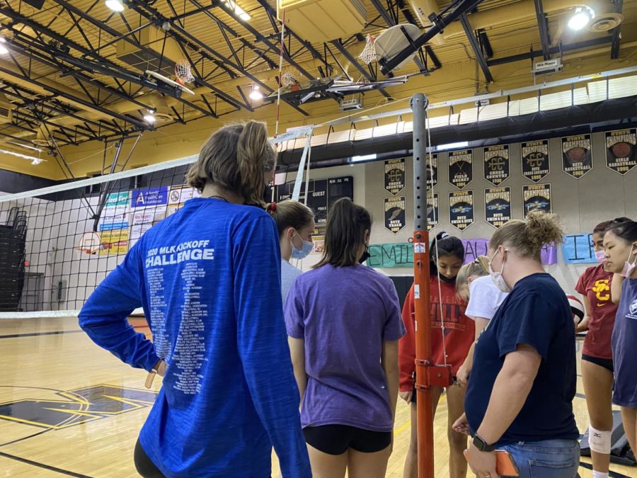 The Girls Varsity Volleyball team sets up the net for their last practice of the season before heading off to playoffs. Our team has created such a good bond and its gonna be hard not to be able to see everyone and socialize with everyone everyday, said freshman Corinne Howard. 