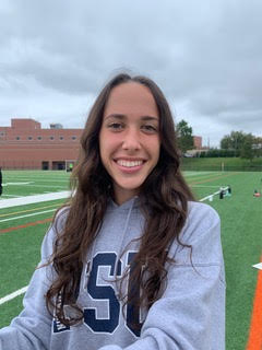 Cori Freundlich, a member of the 2021 homecoming court, poses on the field.