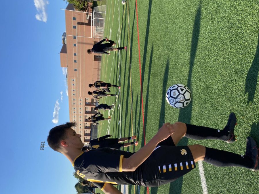 Senior and boys soccer captain Peter Borger warms up with his teammates before his senior night game against Springbrook High School 
