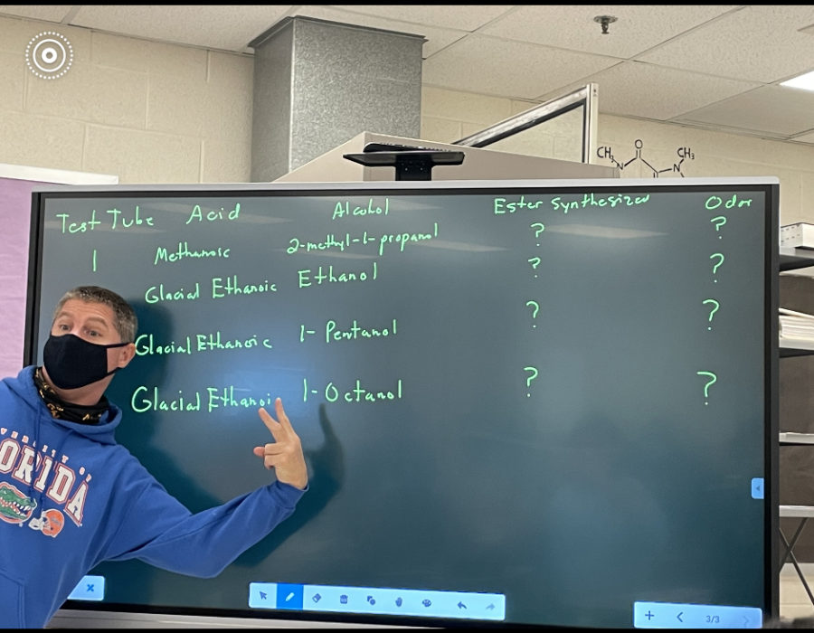 Last month, teachers received a tech  upgrade to their classroom-a new Promethean board. Chemistry teacher Michael Ashmead (pictured standing in front of the board) uses this board to demonstrate the steps for solving complex chemistry problems to his students. Junior  and AP chemistry student Rayan Molkara appreciates the helpful addition. “Personally,  I do benefit from the content being drawn out, especially since we are required to replicate exactly what Mr. Ashmead does,” Molkara said. “Seeing him write out the steps is helpful.”