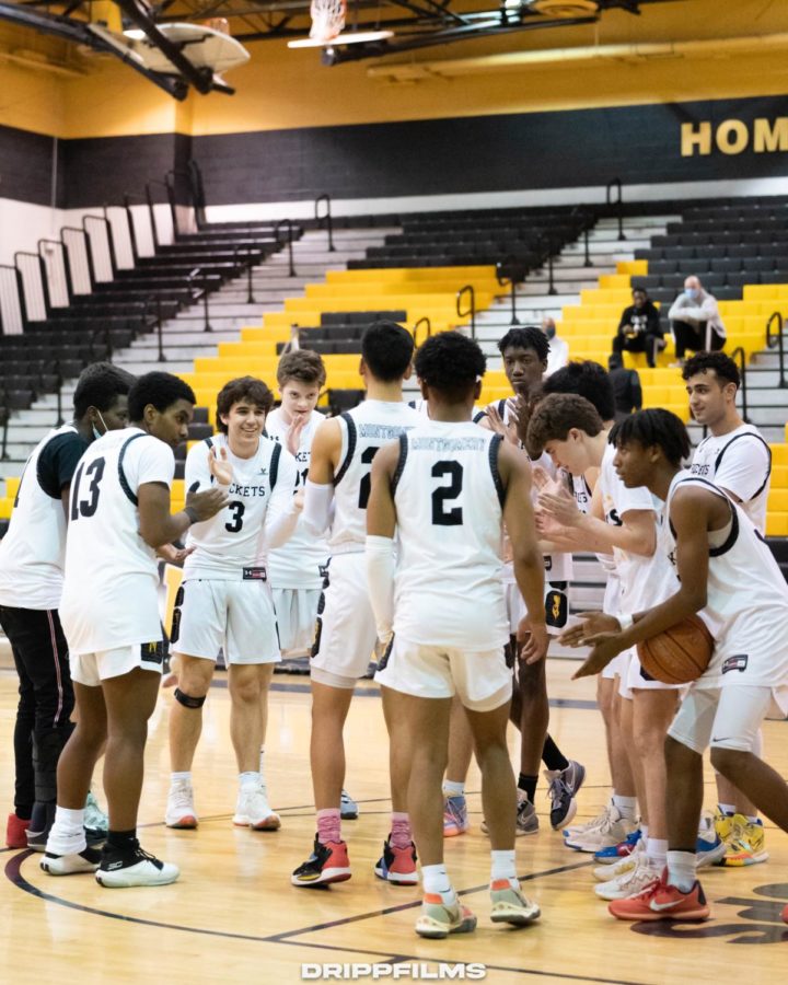 The RM Boys Varsity Basketball team gets hyped up in a team huddle for their first game back with a live audience.