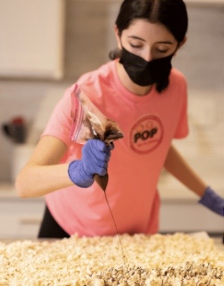 Amanda Kossoff, junior at Churchill High School, makes a batch of chocolate popcorn for her nonprofit organization, Pop for a Cause. 