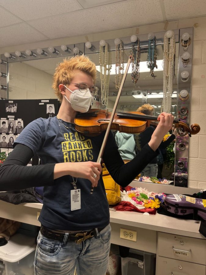 Senior Eleanor Clemens-Cope plays the violin while sporting a Read Banned Books t-shirt. Clemens-Cope is just as passionate for music as she is for environmental activism.