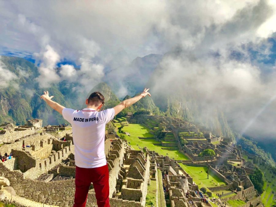 Spanish+teacher+Mr.+Jason+Colchao+poses+by+the+Andes+Mountains+of+Machu+Picchu%2C+Peru.
