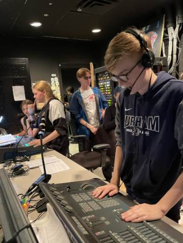 Isaac Gilchrist prepares for his role as Assistant Stage Manager in the play Puffs by checking the sound.