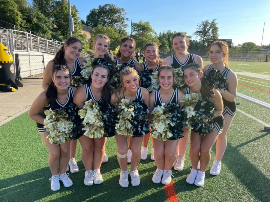 The poms team poses prior to their performance at a football game.