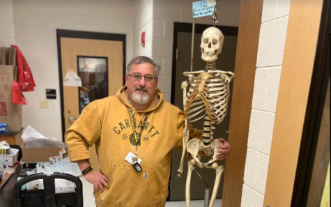 Dr. Kovacs poses beside a real skeleton.