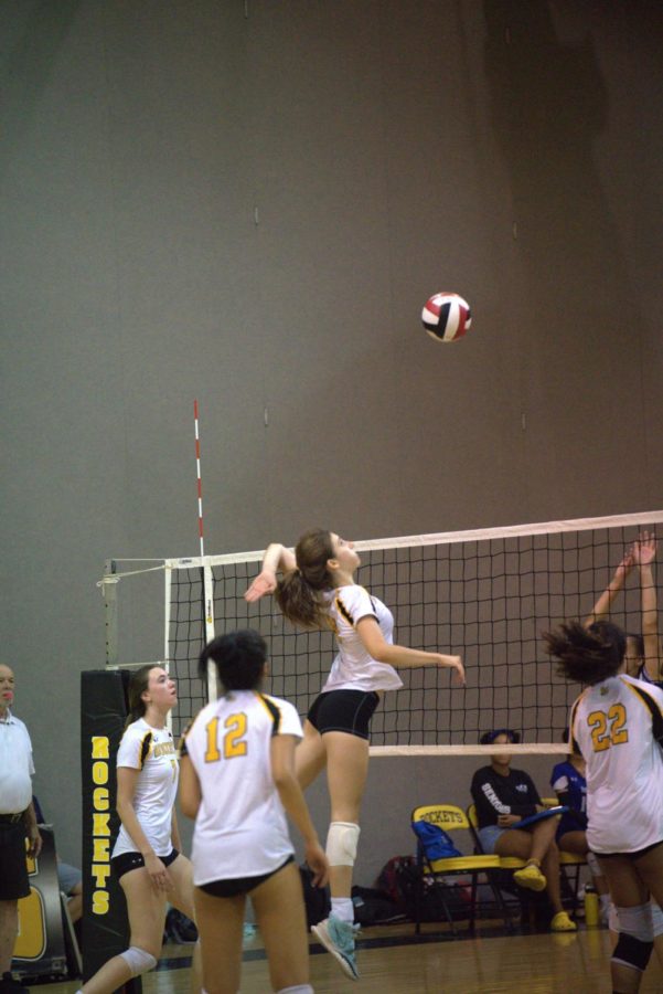 Sophomore Ema Djordjevic jumps up ready for a spike.