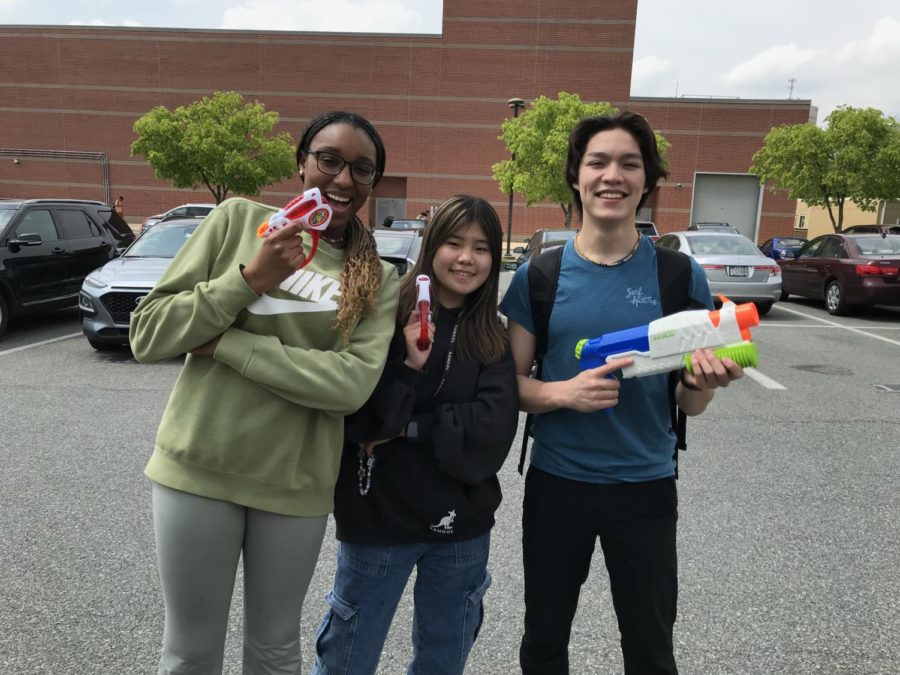 Seniors Anna Jean-Phillipe, Cindy Chen and Kyle Nguyen pose with their water guns.