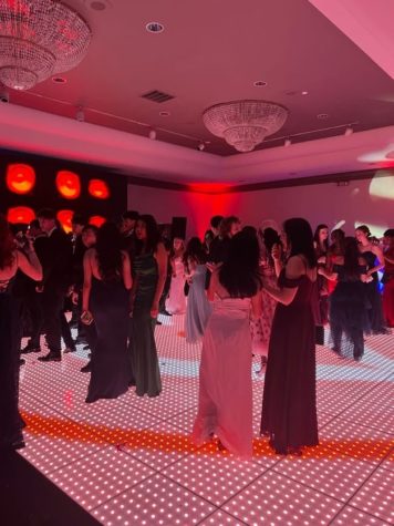 On Friday, May 19 at the Rockville Hilton, Students step onto the dance floor to prepare for a slow dance. “My favorite part was being together with all my friends when good music was playing,” senior Bella Ventimiglia said.