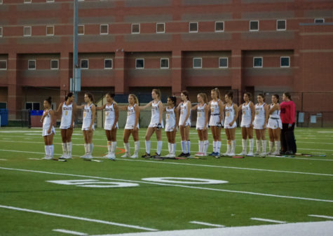 RM varsity field hockey team lines up for the playing of the National Anthem at home.