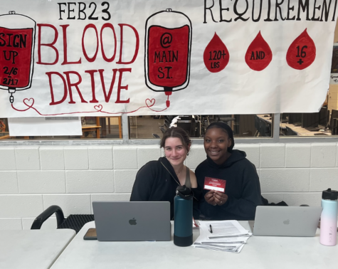 Seniors Lorelai Merritt and Jaiden Burney advertise the blood drive in Main Street during lunch, encouraging eligible students to particpate. The blood drive will be on Feb. 23 during the school day. “Turn in your blood drive form!” said Senior Jaiden Burney.