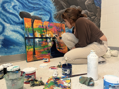 Senior Isari Kodithuwakku, president of the National Art Honor Society, paints a colorful landscape on a canvas. The artwork is part of a Youth Arts for Healing project, a Montgomery County based nonprofit dedicated to bringing youth artwork into healthcare environments. “It’s a big project that we do that basically has a bunch of themes and different size canvases based on the themes, and we’re donating these canvases to hospitals in the local area,” Kodithuwakku said. The paintings will be permanently displayed, and student artists will receive honor society credits for their contributions. “At first I didn’t really think of it as something super impactful, but this year… even though I have all the credits done, I still wanted to do it. I can imagine being in a hospital and not having anything interesting to look at every day.”