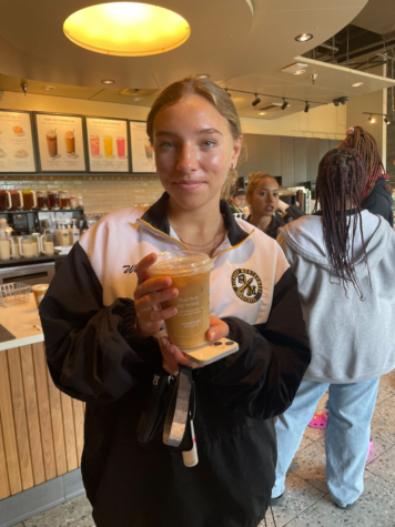 Junior Hailey Welter poses with her Caramel Macchiato.