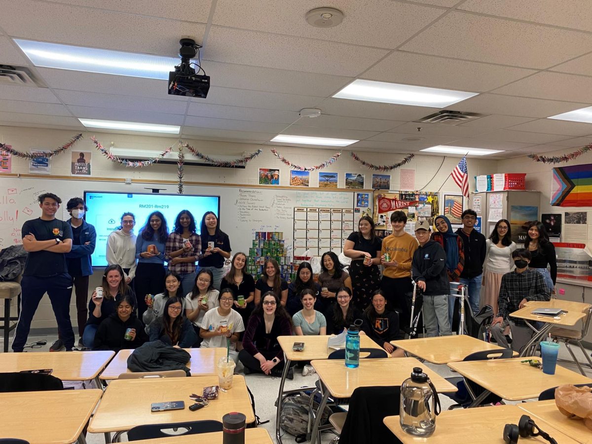 Ms. Fry’s first period TOK 2 class poses with the 242 cans they brought in on Nov. 10, the last day of the SGA’s canned food drive. (Photo permission granted by Kerri Fry)