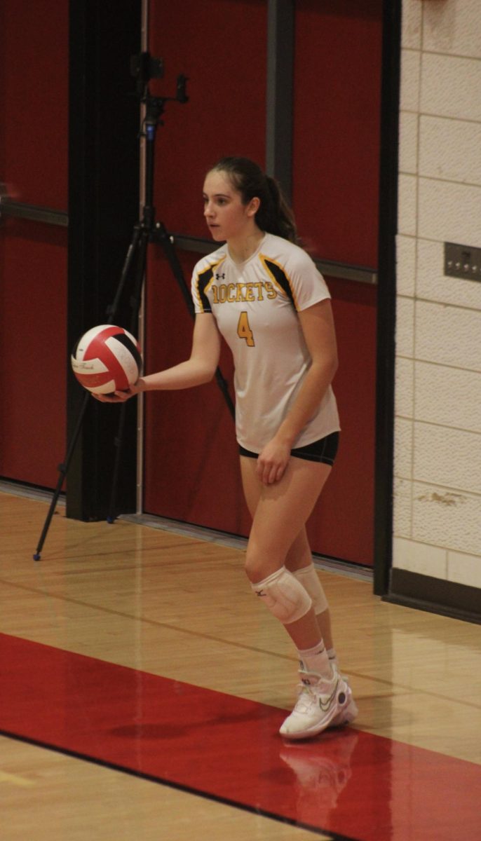 Junior Ema Djordjevic prepares to serve against Wootton HS in the county championship game.