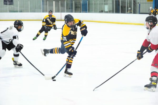 Senior Tom Stone prepares to shoot the puck in a RM varsity hockey game. 