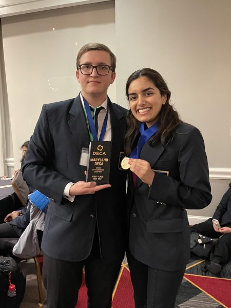 RM DECA co-presidents and seniors Max Belyantsev and Nandi Patel pose with the teams SCDC Oustanding Chapter trophy. 