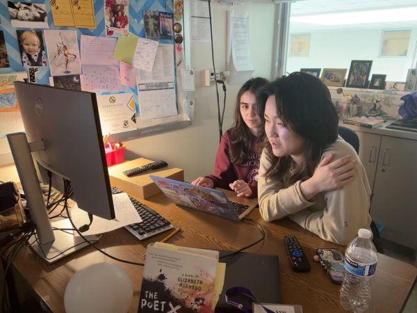 Seniors and Fine Lines Editors Dasha Melikova and Chloe Choi discuss a submission for the magazine. 