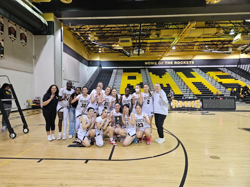 The girls basketball teams poses after winning the regional championship.