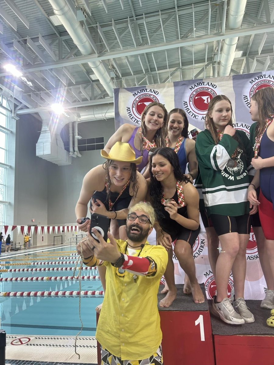 Coach Gandhi takes a selfie with members of the team after winning the state title