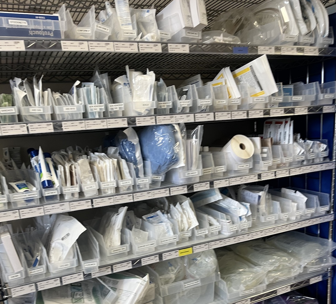 Shelves inside a hospital supply several types of medical supplies. 