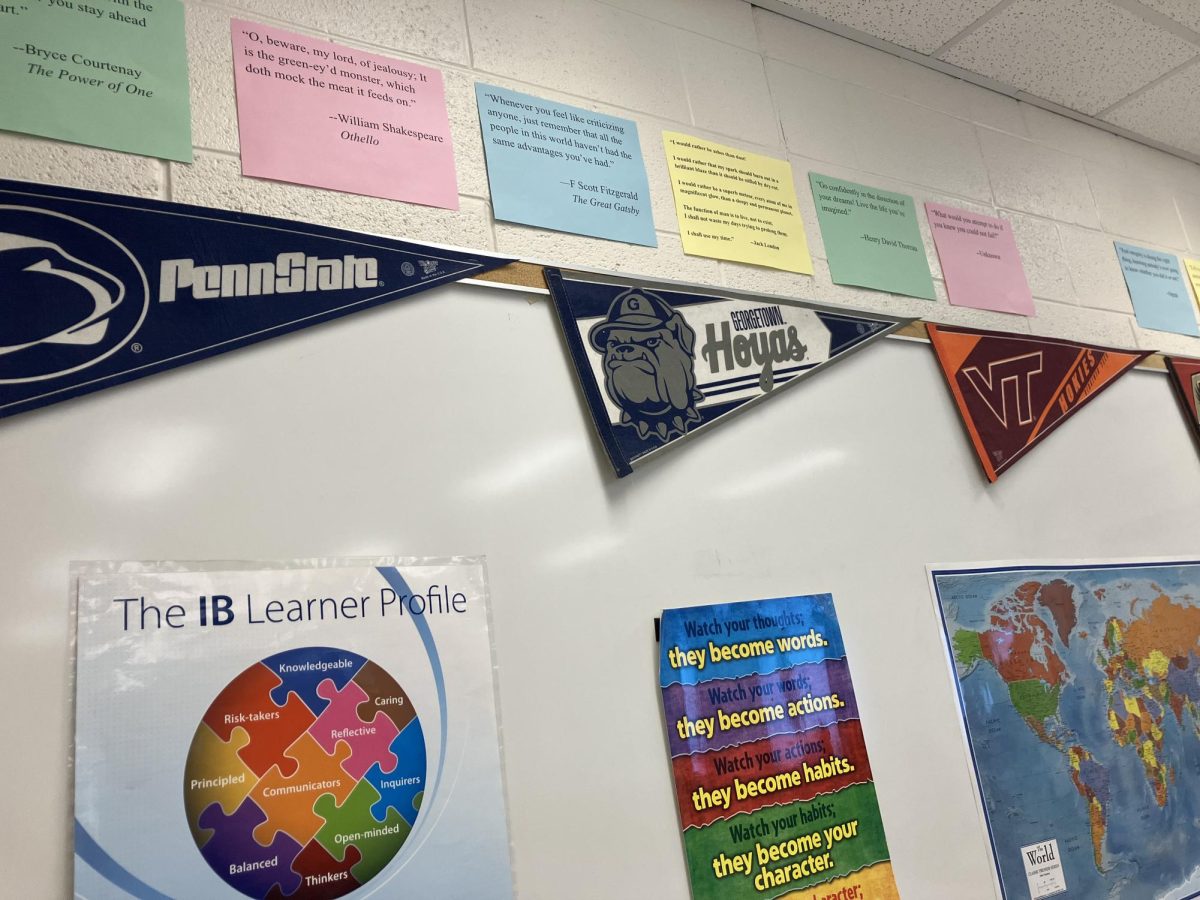 English teacher Michael Oakes hangs banners from various colleges and universities in his classroom.