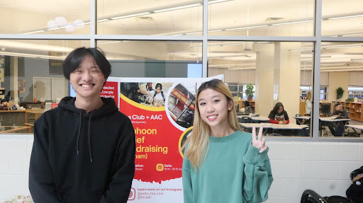 Seniors Mark Yang and Tiffany Liao, co-presidents of Tea Club, pose in front of the fundraising table on Oct. 17.