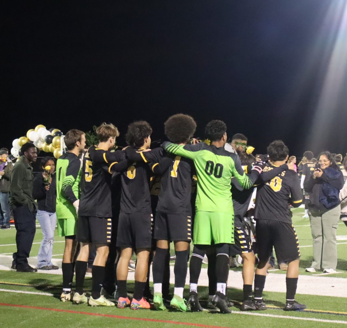 The boys soccer team huddles together after their game against WJ on Oct. 14.