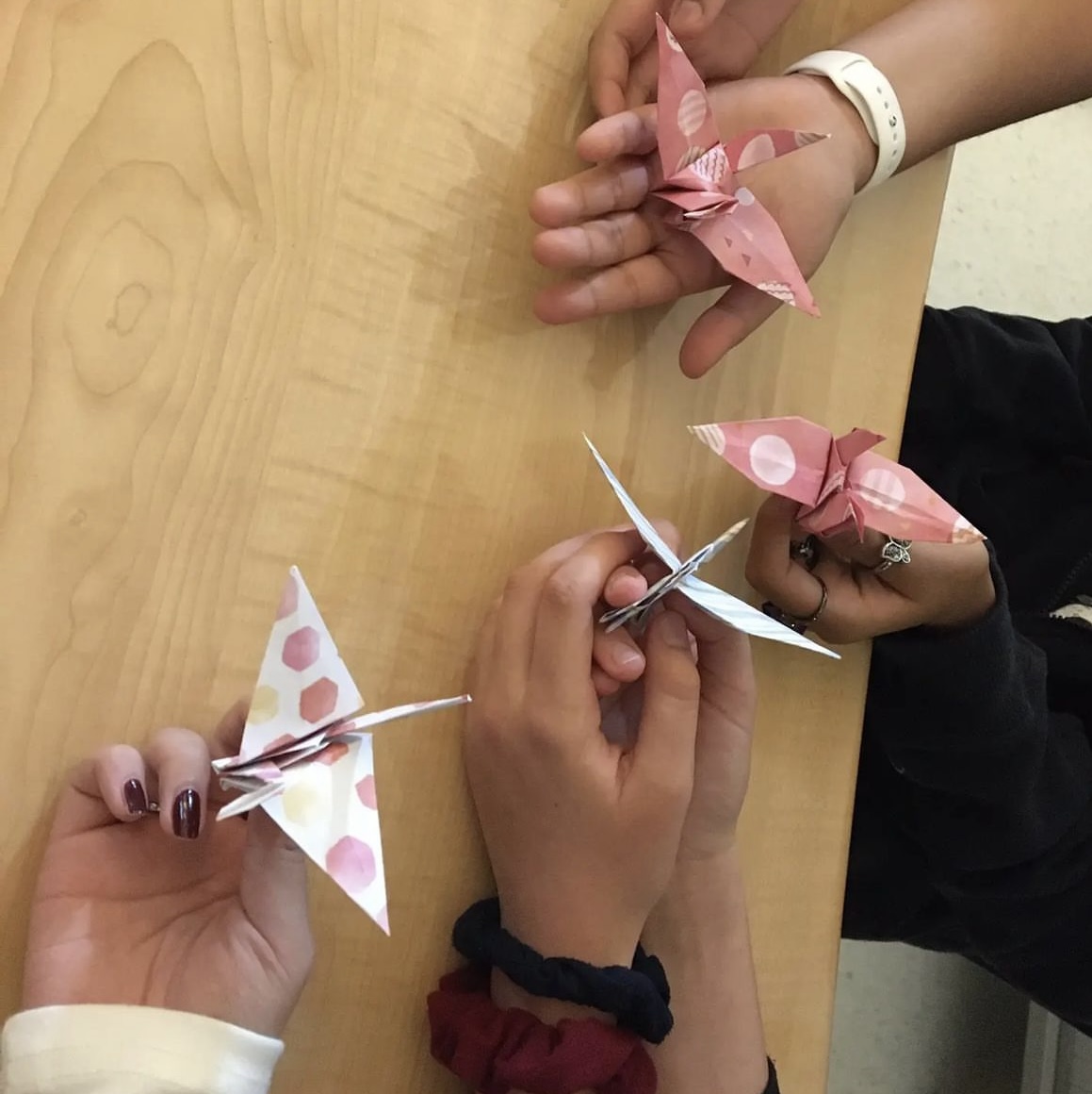 Students in Origami Club display a paper crane project they worked on together, courtesy of Origami Club.