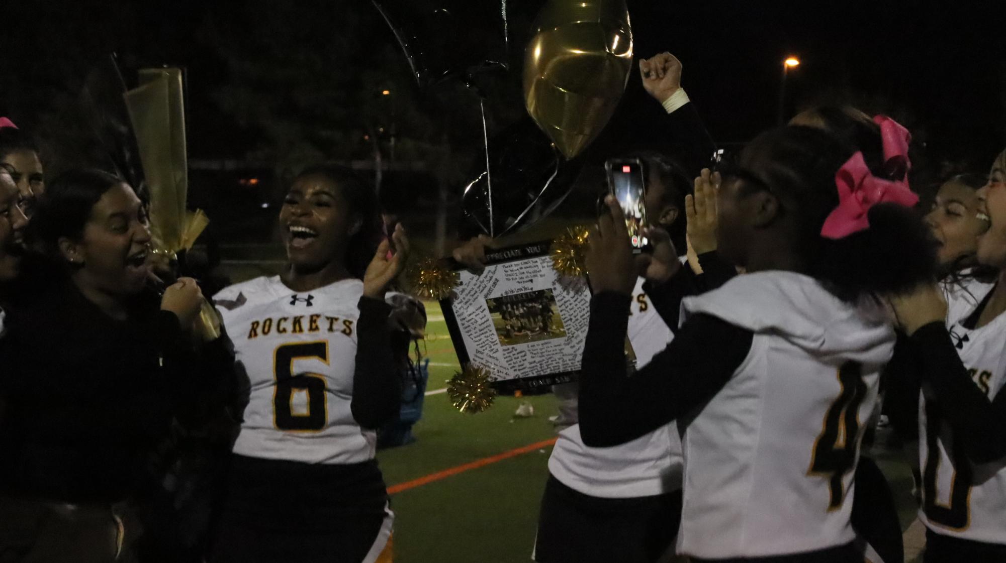 Cheer seniors celebrate after a performance. 