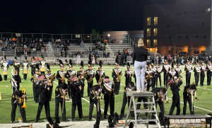 The marching band performs during halftime at a football game, featuring a fan-favorite blindfolded routine by the trombone players.