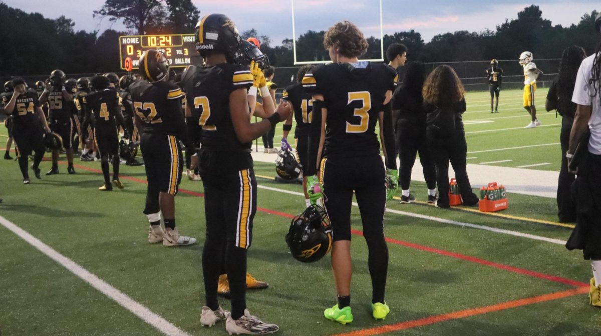 Seniors Axel Ramos and Alden Croarkin speak on the sideline as they wait for their next play. 