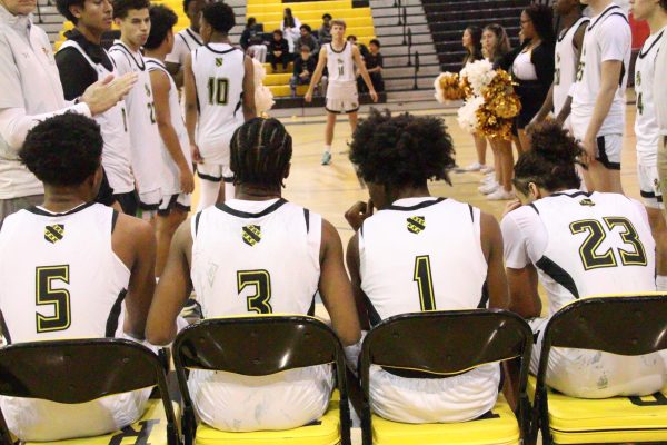 Starting basketball players prepare to go on the court ahead of a game. 