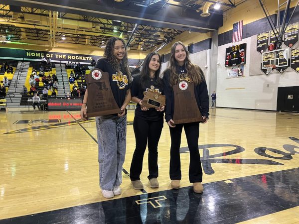 Navigation to Story: Photo of the Day : Girls’ Volleyball recognized at basketball game