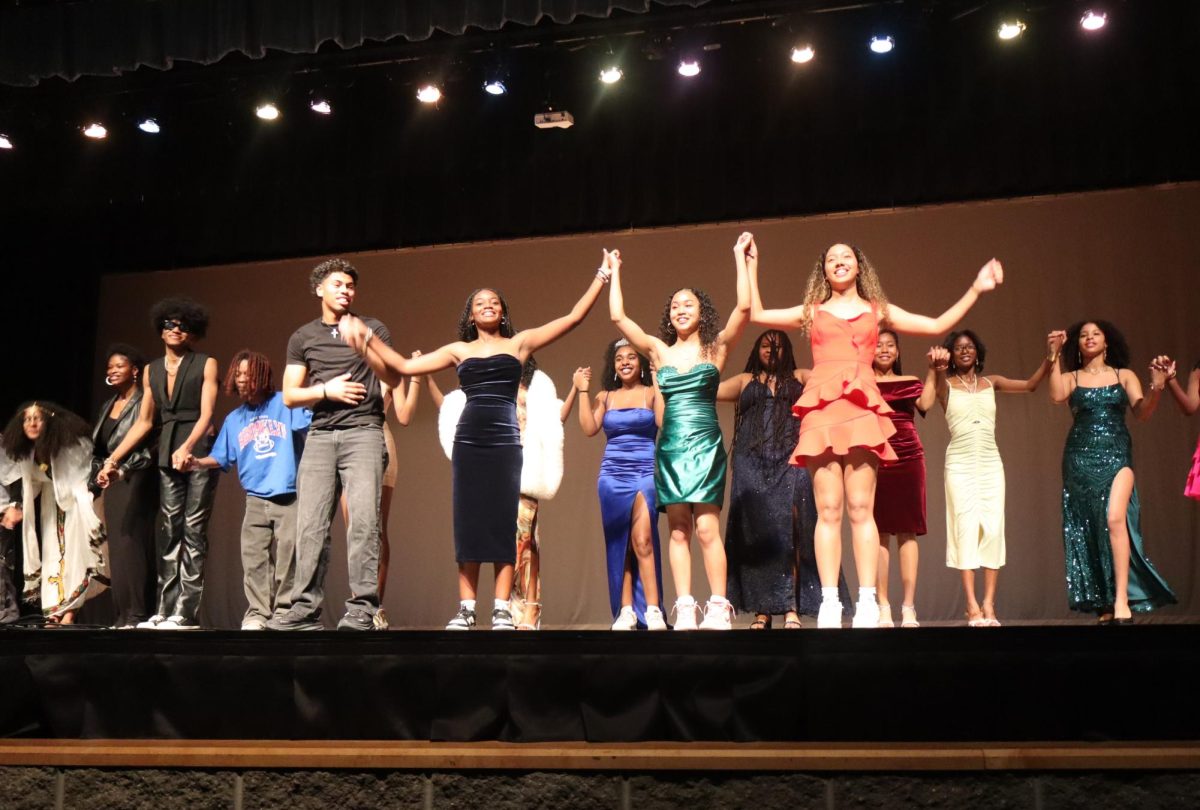 Seniors Solomon Snowdy, Madison Carter, Mara Porter, and Corinne Howard join hands along with all the other performers to take a final bow and end the show. 