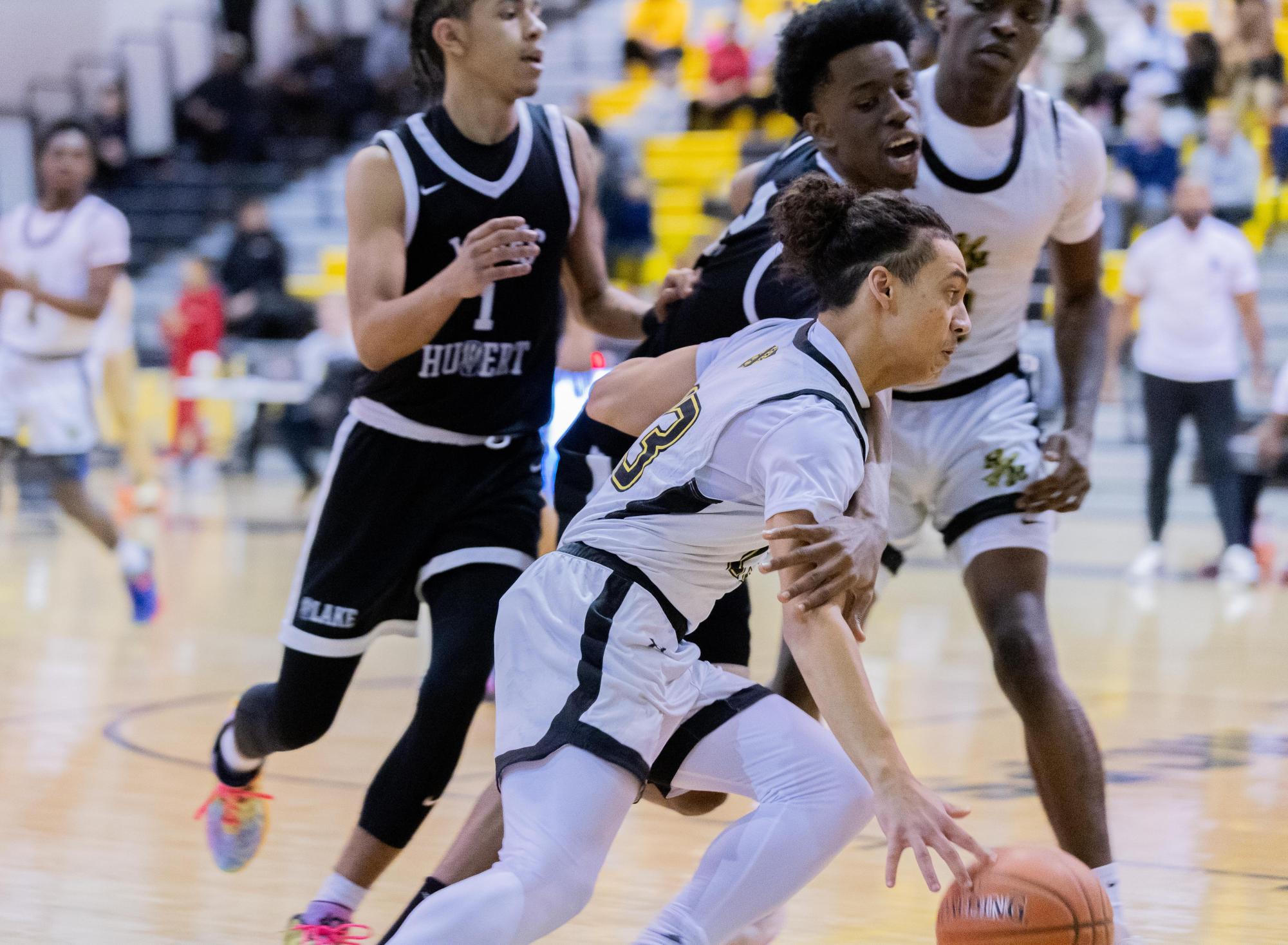 Junior Gerard Woods goes past against a Blake defender. Woods finished with 11 points, and was strong in the paint with a 40% 2FG percentage. 