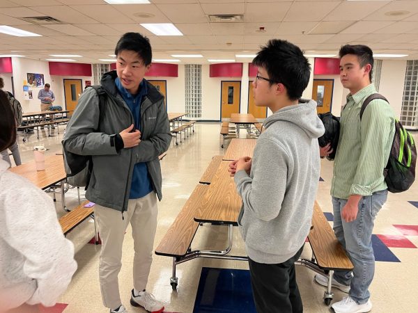 Senior Richard Zhu, junior Derek Wang and sophomore Sedric Su discuss their answers after the final round of the MoCo Math Meets Wednesday, Feb. 19. 