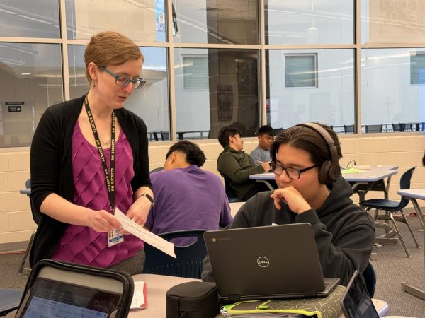 Ms. Vogel works with junior Justin Diaz at Homework Club in the media center Tuesday, Mar. 25.